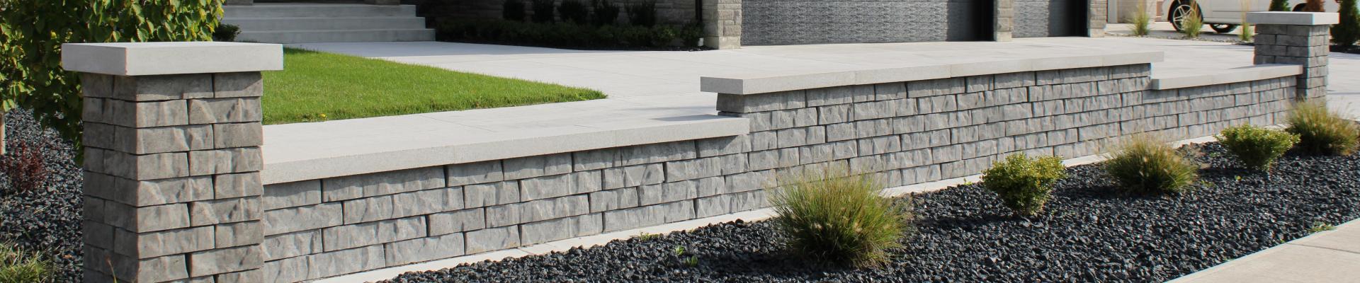 Covered sitting area with stone columns and plants