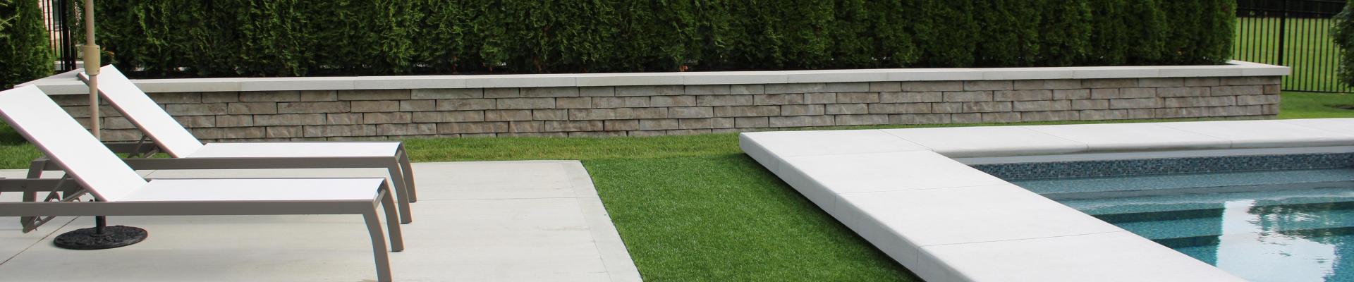 Stone retaining wall with shrubs and flowers